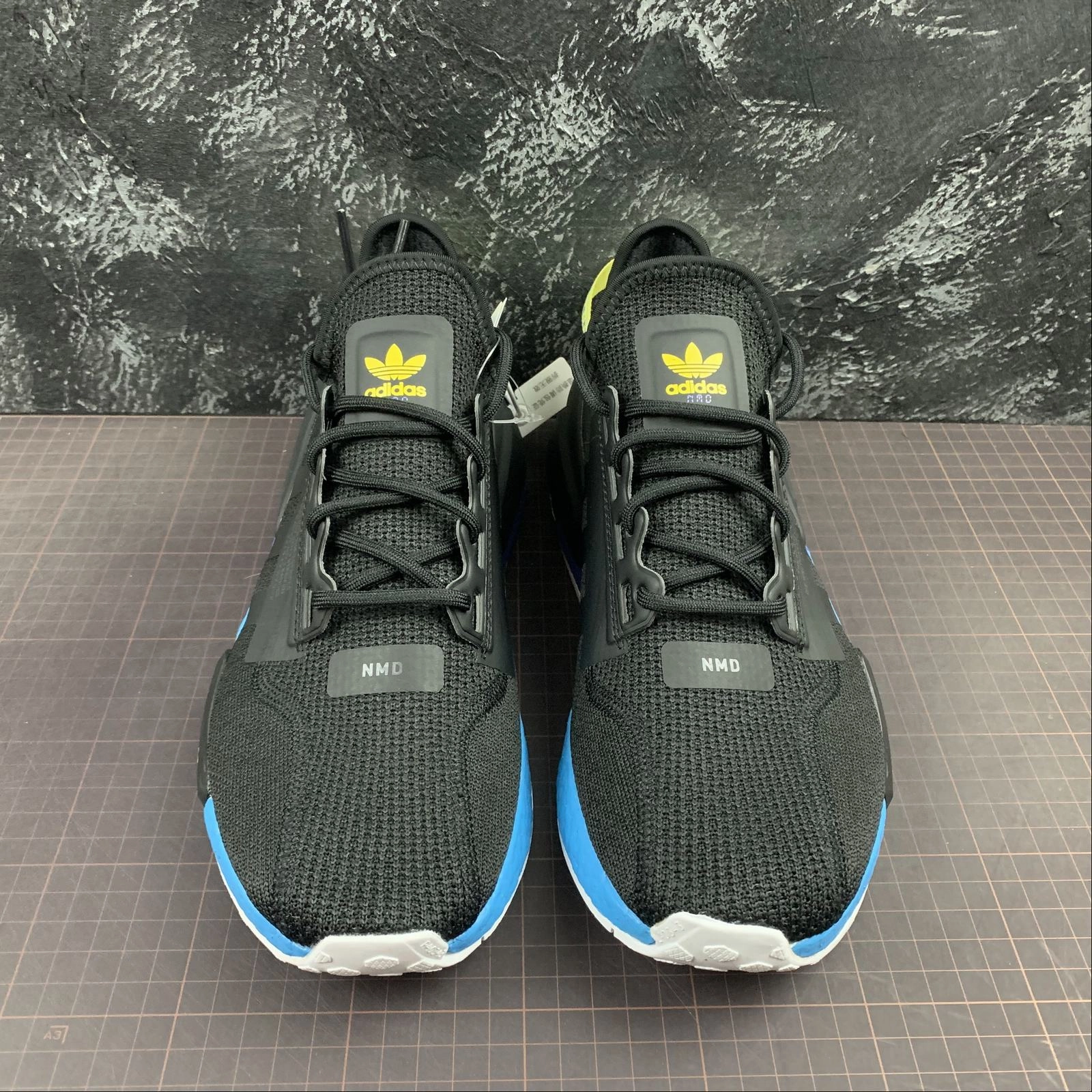 long - distance runner track meet running shoes Adidas NMD R1 V2 Black Carbon Shock Yellow