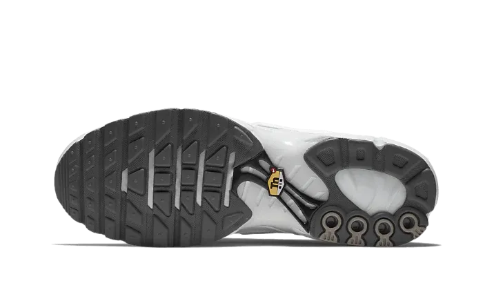 Nike Air Max Plus Triple White Reinforced Soles running in a park trail