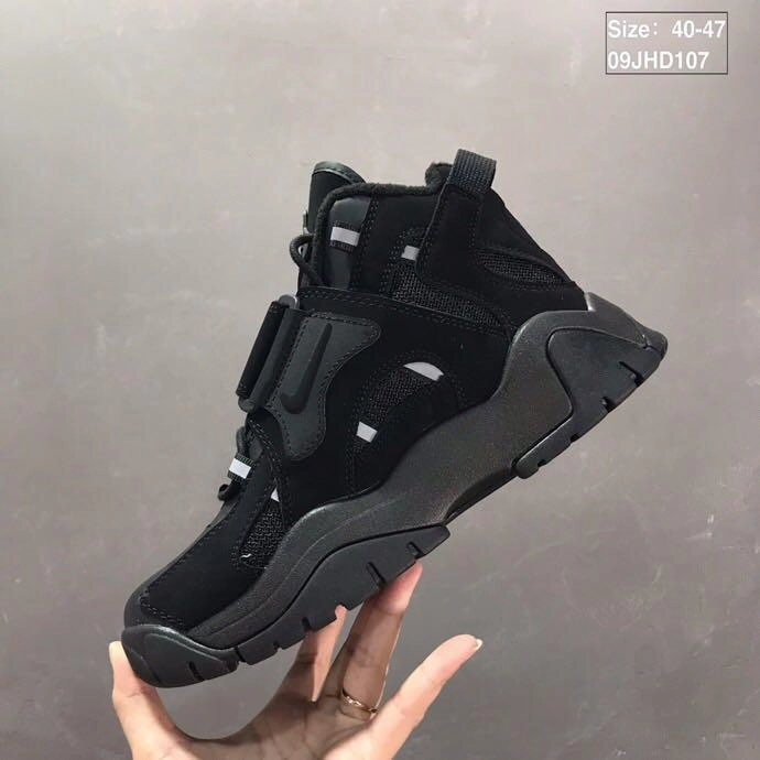 Air Barrage Mid QS Black Full AT7847-002 running in a tram station area shoes