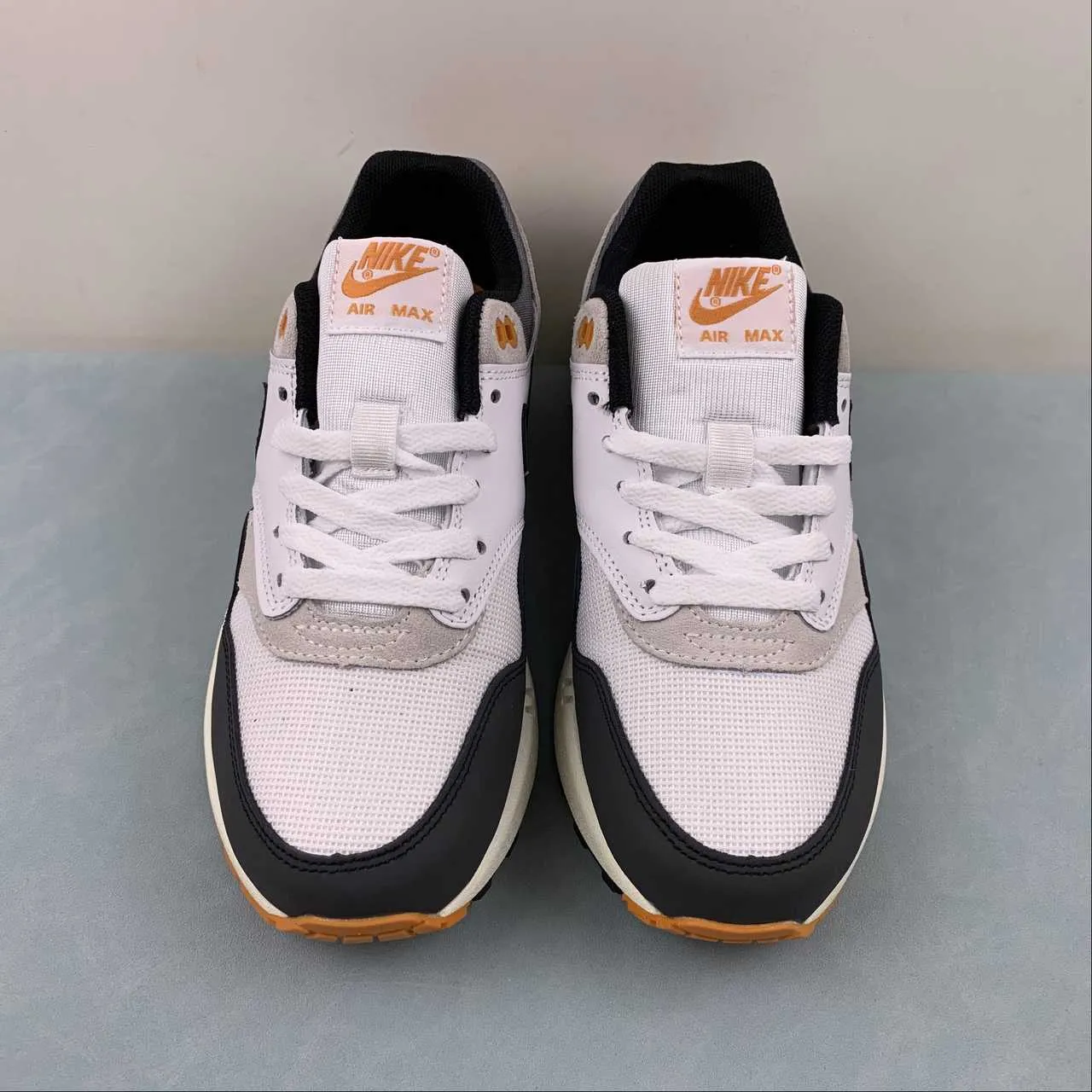 running in a volleyball court area shoes Air Max 1 Athletic Deptment Black Forest Neutral Grey Varsity Maize FN7487-133