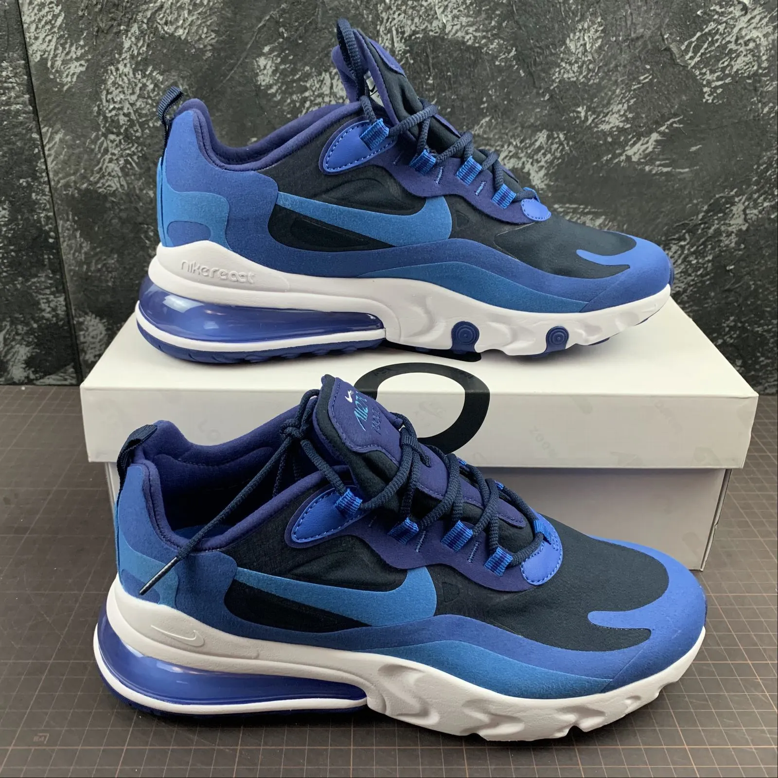 Air Max 270 React Blue Void Photo Blue AQ4971-400 running in a ferry terminal area shoes