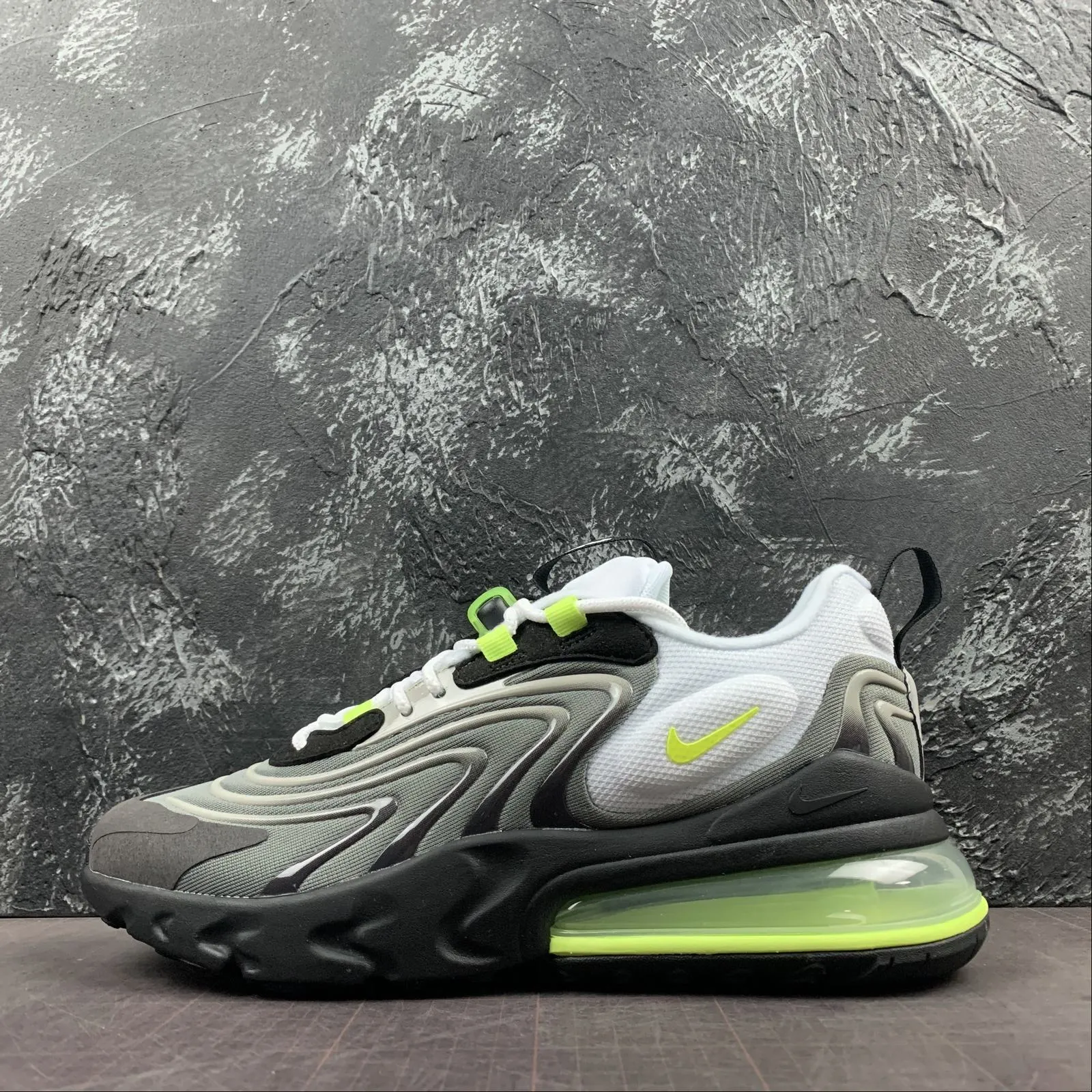 running in a light rail station area shoes Air Max 270 React ENG Dust Volt-Dk Pewter-Medium Ash CW2623-001